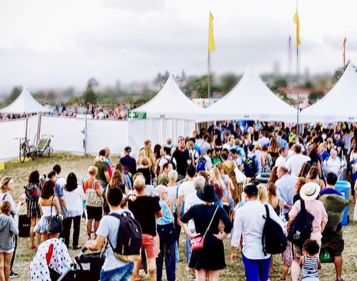 music-festival-large-crowd-queuing-to-enter-the-festival-venue-real-life-candid-copy-space_t20_doWzxA