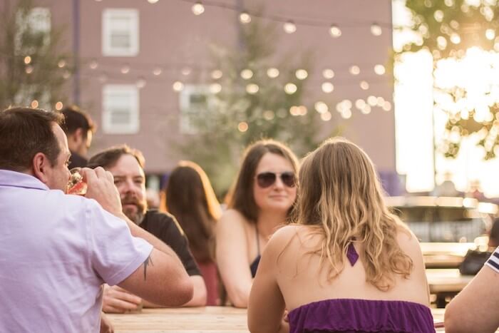 friends-having-drinks-outside-at-eastside-in-denton-tx_t20_eo0l0o